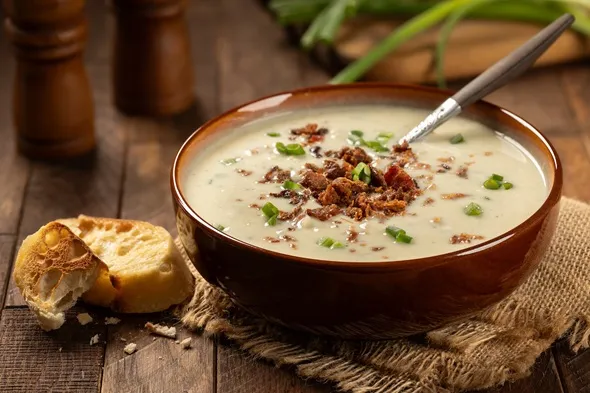 Creamy potato soup with bacon pieces and chopped green onion